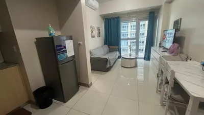 a kitchen with a refrigerator and a living room at Bayshore 2 Okada Bayview WiFi Big TV Netflix Near NAIA&MOA in Manila