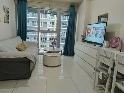 a bedroom with a bed and a tv and a window at Bayshore 2 Okada Bayview WiFi Big TV Netflix Near NAIA&MOA in Manila