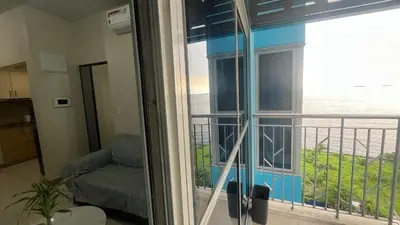 a room with a window with a view of the ocean at Bayshore 2 Okada Bayview WiFi Big TV Netflix Near NAIA&MOA in Manila