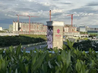 a pillar with a sign on it in front of a city at Bayshore 2 Okada Bayview WiFi Big TV Netflix Near NAIA&MOA in Manila