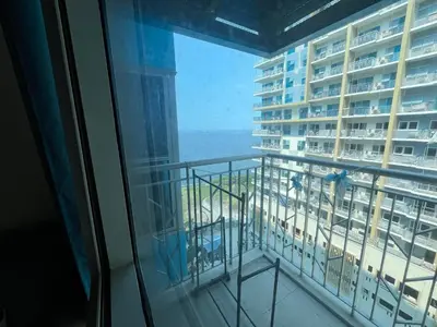 a view of the ocean from a balcony in a hotel at Bayshore 2 Okada Bayview WiFi Big TV Netflix Near NAIA&MOA in Manila