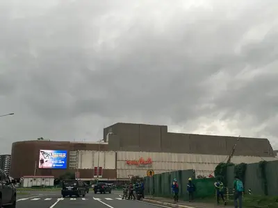 a large building with people on bikes in front of it at Bayshore 2 Okada Bayview WiFi Big TV Netflix Near NAIA&MOA in Manila