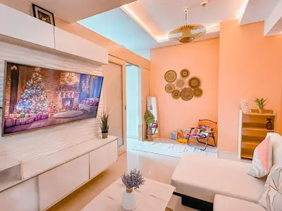 a living room with a large flat screen tv at Aeva's Cozy Stay in Manila