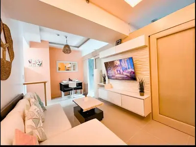 a living room with a couch and a piano at Aeva's Cozy Stay in Manila