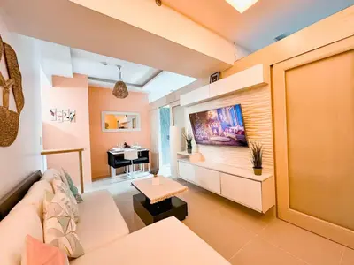 a living room with a couch and a piano at Aeva's Cozy Stay in Manila