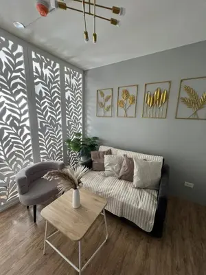 a living room with a couch and a table at Ananda Square in Manila