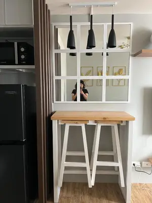 a person taking a picture of a table in a kitchen at Ananda Square in Manila