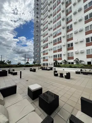 a courtyard with benches in front of a building at Ananda Square in Manila