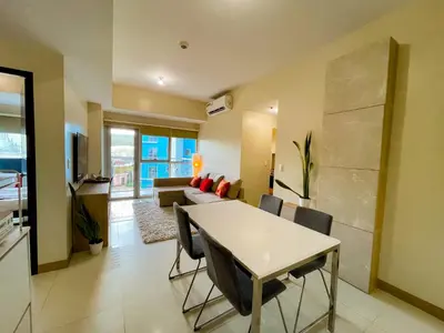 a living room with a table and a couch at Bayshore Resort Residences - Okada Manila in Manila