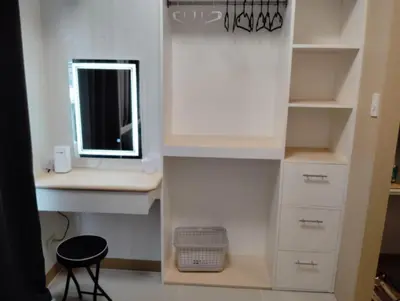 a bathroom with a desk with a mirror and a sink at Condo sa south residences tower 3 in Manila