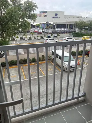 a balcony with a car parked in a parking lot at Condo sa south residences tower 3 in Manila