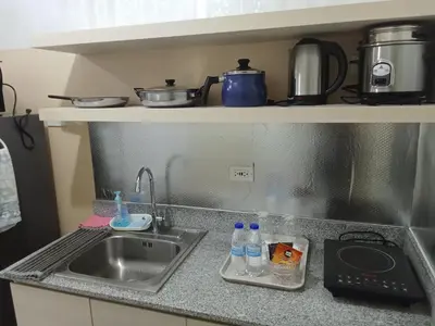 a kitchen counter with a sink and a sink at Condo sa south residences tower 3 in Manila
