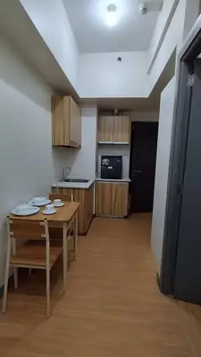 a kitchen with a table and a kitchen with a counter at Yuanhang 910 in Manila