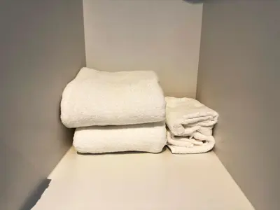 two towels are sitting on the floor in a bathroom at Elegant 1 bedroom apartment with great facilities and perfect location in Manila