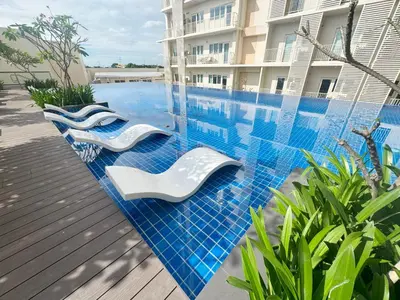 a swimming pool with blue tiles on the side of a building at Elegant 1 bedroom apartment with great facilities and perfect location in Manila