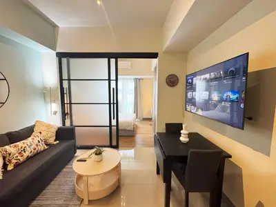 a living room with a couch and a table at Elegant 1 bedroom apartment with great facilities and perfect location in Manila