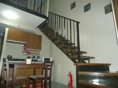 a kitchen with a spiral staircase in a house at Mondavi II Condo Unit 306 in Silang