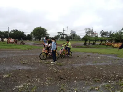 a group of people on bikes in a field at Mondavi II Condo Unit 306 in Silang