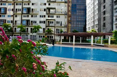 a swimming pool in a city with tall buildings at Mondavi II Condo Unit 306 in Silang