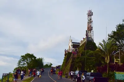 a group of people walking down a street with a tower at Mondavi II Condo Unit 306 in Silang