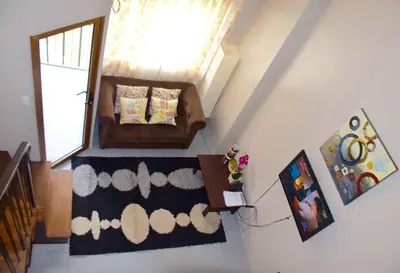 a living room with a couch and a window at Mondavi II Condo Unit 306 in Silang