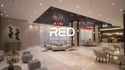 a red reserves store with couches and tables in a lobby at HyrCondotel in Manila