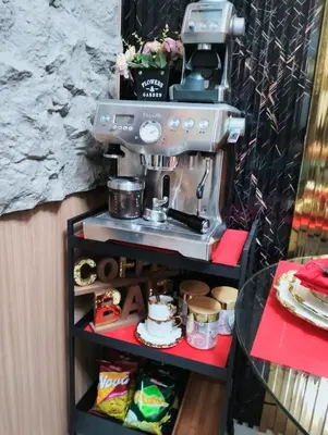 a coffee maker on a shelf with food at HyrCondotel in Manila
