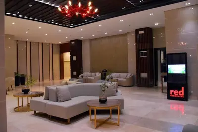 a living room with couches and tables and a television at HyrCondotel in Manila