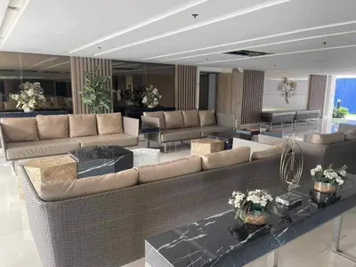 a large living room with couches and tables at King Elite Condo Hotel Field Residences Near NAIA Airport in Manila