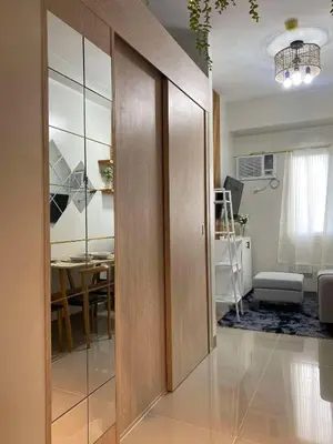 a room with a sliding door with a dining room at R & A Enclave in Manila
