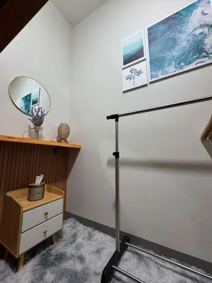 a room with a staircase and a mirror on the wall at R & A Enclave in Manila