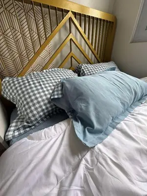 a bed with two pillows on top of it at R & A Enclave in Manila