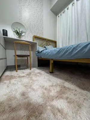 a bedroom with a bed and a rug at R & A Enclave in Manila