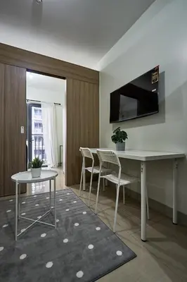 a dining room with a table and chairs in a room at Cozy Home near Mall of Asia with WIFI and Netflix in Manila