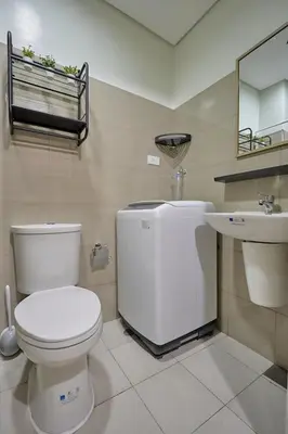 a bathroom with a toilet and a sink at Cozy Home near Mall of Asia with WIFI and Netflix in Manila