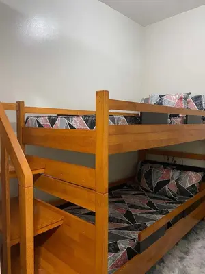a wooden bunk bed in a room at R and A Enclave in Manila