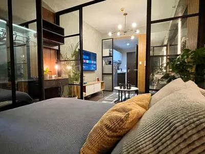 a bedroom with a large bed and a television at Luxurious 500MBPS 1BR in Makati in Manila