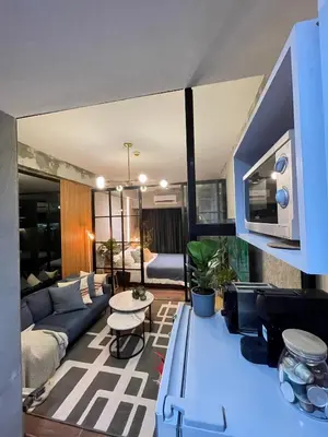 a living room with a couch and a table at Luxurious 500MBPS 1BR in Makati in Manila