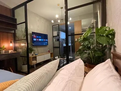 a living room with a couch and a tv at Luxurious 500MBPS 1BR in Makati in Manila