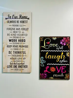 two framed posters on a wall with a poem at 7FF Cozy 1BR Park McKinley West near BGC & Venice Mall in Manila