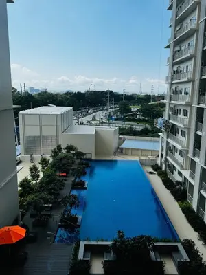 an overhead view of a swimming pool on a building at 7FF Cozy 1BR Park McKinley West near BGC & Venice Mall in Manila