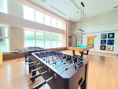 a large room with two billiard tables in it at 7FF Cozy 1BR Park McKinley West near BGC & Venice Mall in Manila