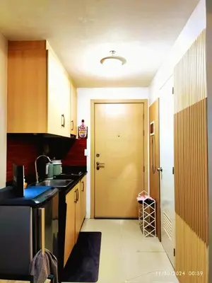 a kitchen with a door leading into a kitchen with a sink at Casa Cashmere in Light residences at Mandaluyong City in Manila