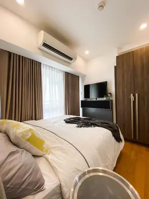 a bedroom with a large white bed and a window at Studio unit at The Milano Residences in Manila