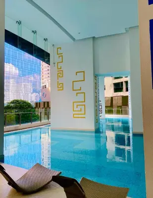 a hotel room with a swimming pool and a hotel sign at Studio unit at The Milano Residences in Manila