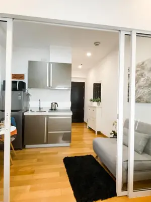 a kitchen and living room with a bed and a sink at Studio unit at The Milano Residences in Manila