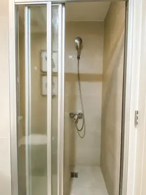 a shower with a shower head in a bathroom at Studio unit at The Milano Residences in Manila