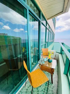 a balcony with a table and chairs on a building at Baywtach 1503 in Manila