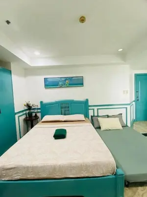 a bedroom with two blue beds in a room at Baywtach 1503 in Manila