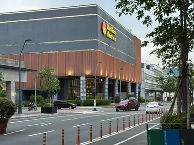 a building on a street with cars parked in front of it at 1BR 2 mins to Okada near MOA & Airport-12C in Manila